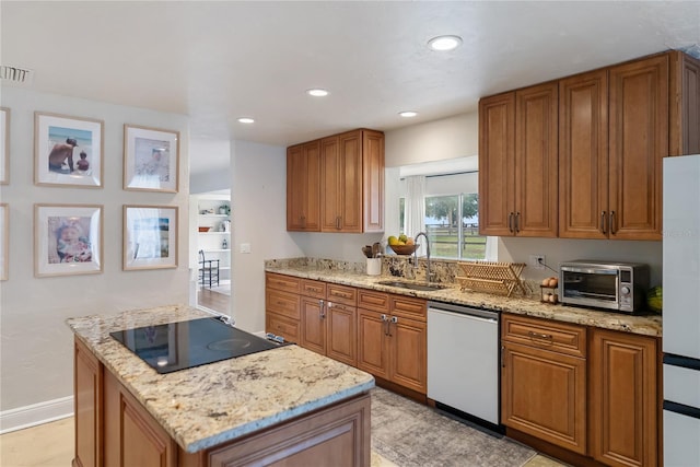 3810 Hidden River Rd, Sarasota, FL 34240 - kitchen with a sink, dishwasher, cooktop, brown cabinets, and a kitchen island