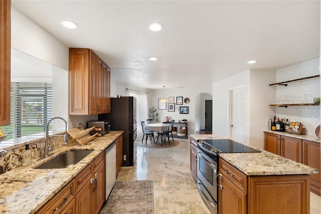 3810 Hidden River Rd, Sarasota, FL 34240 - kitchen with stainless steel appliances, a sink, plenty of natural light, arched walkways, and recessed lighting