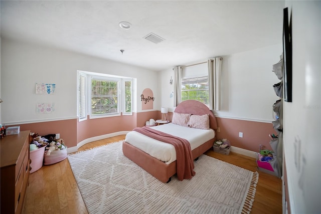 3810 Hidden River Rd, Sarasota, FL 34240 - bedroom with multiple windows, wood finished floors, and baseboards
