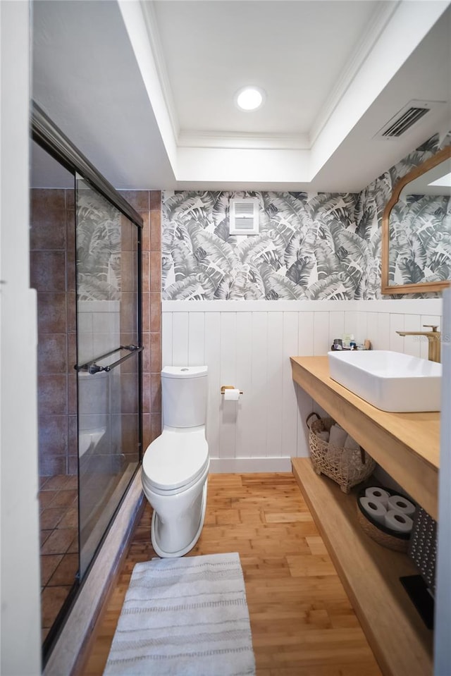 3810 Hidden River Rd, Sarasota, FL 34240 - bathroom with a raised ceiling, wainscoting, a stall shower, wood finished floors, and toilet