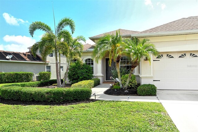 12358 Lavender Loop, Bradenton, FL 34212 - view of front of house with an attached garage, stucco siding, a front yard, and driveway