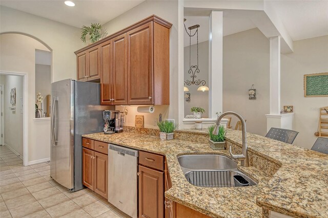 12358 Lavender Loop, Bradenton, FL 34212 - kitchen with appliances with stainless steel finishes, a sink, brown cabinetry, light stone countertops, and recessed lighting
