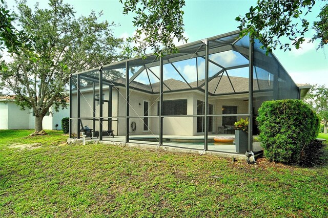 12358 Lavender Loop, Bradenton, FL 34212 - back of property featuring a patio area, a yard, glass enclosure, and an outdoor pool