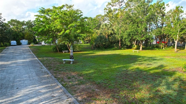 950 Trotter St, Nokomis, FL 34275 - view of green lawn featuring a garage