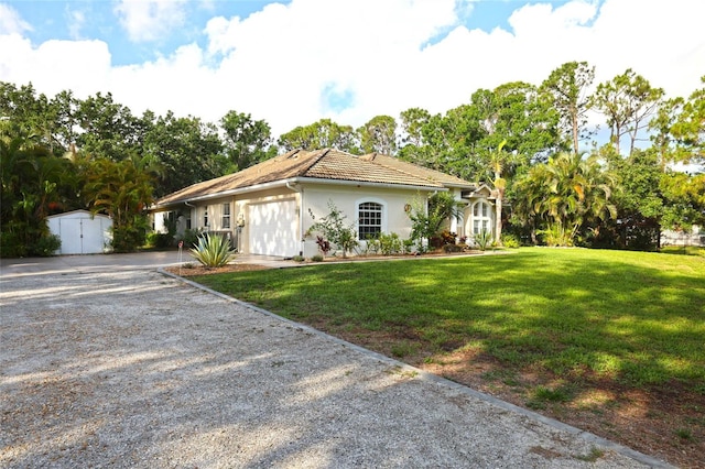 950 Trotter St, Nokomis, FL 34275 - view of front of property featuring driveway, a front lawn, stucco siding, a tiled roof, and a garage