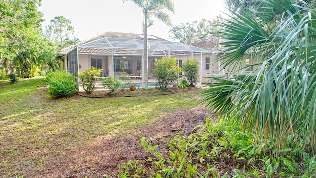 950 Trotter St, Nokomis, FL 34275 - back of property featuring a yard, a lanai, stucco siding, and an outdoor pool