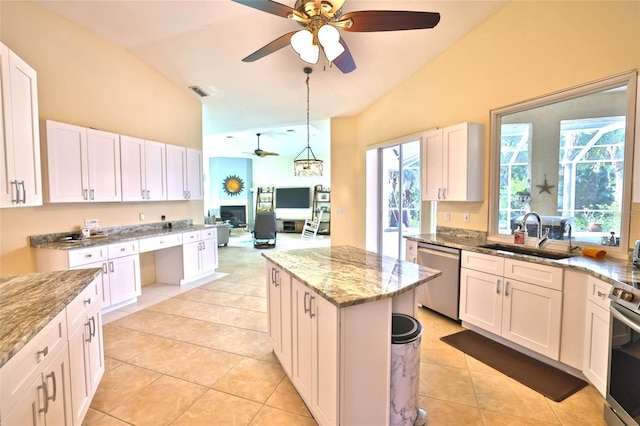 950 Trotter St, Nokomis, FL 34275 - kitchen with a sink, stainless steel appliances, ceiling fan, high vaulted ceiling, and light stone counters