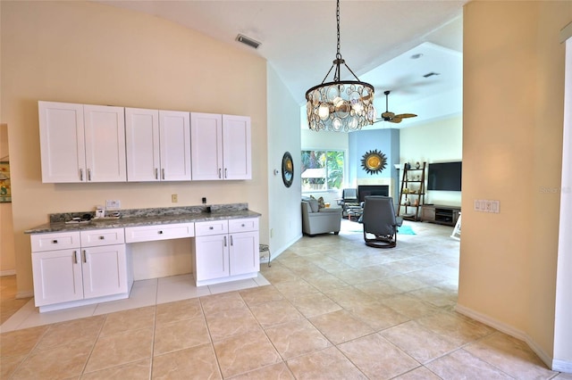 950 Trotter St, Nokomis, FL 34275 - kitchen featuring high vaulted ceiling, open floor plan, a chandelier, light tile patterned floors, and white cabinets