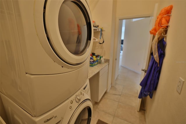 950 Trotter St, Nokomis, FL 34275 - washroom with stacked washer / dryer and light tile patterned floors