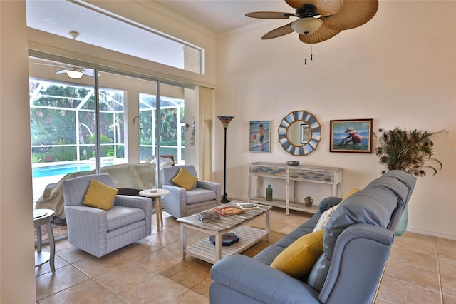950 Trotter St, Nokomis, FL 34275 - living room with ceiling fan, tile patterned floors, a sunroom, crown molding, and a towering ceiling