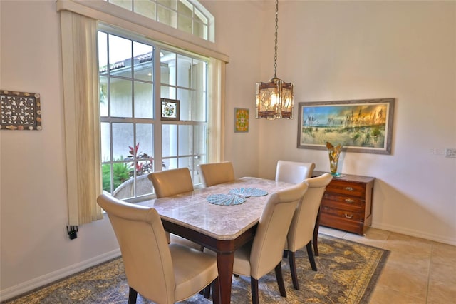 950 Trotter St, Nokomis, FL 34275 - tiled dining space featuring a chandelier and baseboards