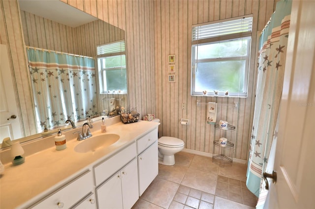950 Trotter St, Nokomis, FL 34275 - bathroom with healthy amount of natural light, wallpapered walls, vanity, toilet, and tile patterned floors
