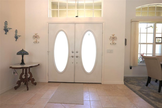950 Trotter St, Nokomis, FL 34275 - foyer with a high ceiling, light tile patterned floors, baseboards, and french doors