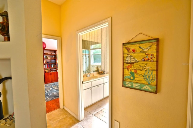 950 Trotter St, Nokomis, FL 34275 - corridor featuring light tile patterned floors and a sink