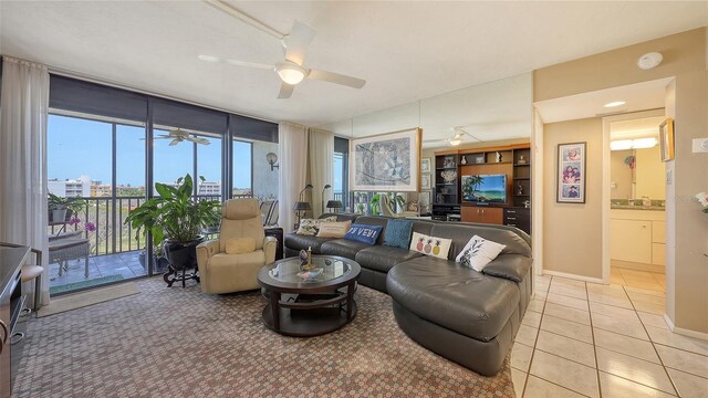 2045 Gulf Of Mexico Dr Unit M1-514, Longboat Key, FL 34228 - living area with light tile patterned floors, a ceiling fan, and baseboards