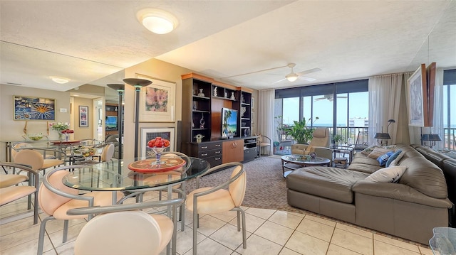 2045 Gulf Of Mexico Dr Unit M1-514, Longboat Key, FL 34228 - living room with light tile patterned flooring, ceiling fan, and a textured ceiling