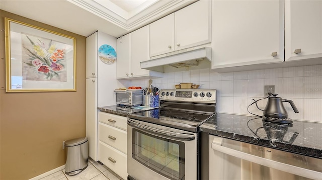 2045 Gulf Of Mexico Dr Unit M1-514, Longboat Key, FL 34228 - kitchen with appliances with stainless steel finishes, under cabinet range hood, decorative backsplash, white cabinetry, and dark stone countertops