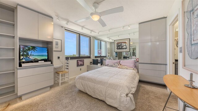 2045 Gulf Of Mexico Dr Unit M1-514, Longboat Key, FL 34228 - bedroom with rail lighting, light carpet, and a ceiling fan