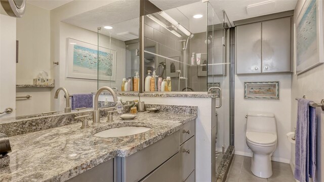 2045 Gulf Of Mexico Dr Unit M1-514, Longboat Key, FL 34228 - full bathroom with vanity, toilet, a shower stall, tile patterned floors, and baseboards