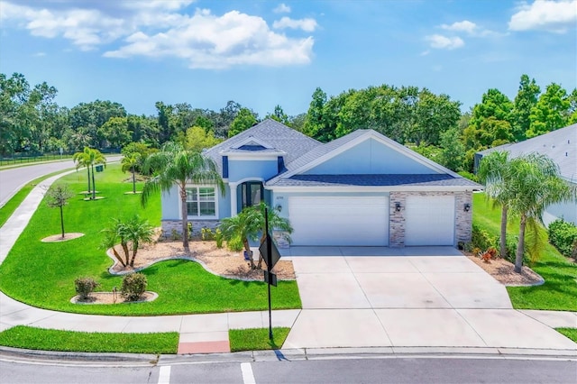 12755 Rainwashed Loop, Parrish, FL 34219 - single story home featuring an attached garage, driveway, a front yard, stone siding, and stucco siding
