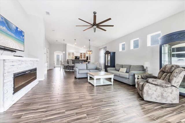 12755 Rainwashed Loop, Parrish, FL 34219 - living area with a ceiling fan, healthy amount of natural light, wood finished floors, a fireplace, and high vaulted ceiling