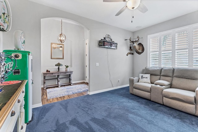 12755 Rainwashed Loop, Parrish, FL 34219 - carpeted living room with ceiling fan, arched walkways, and baseboards