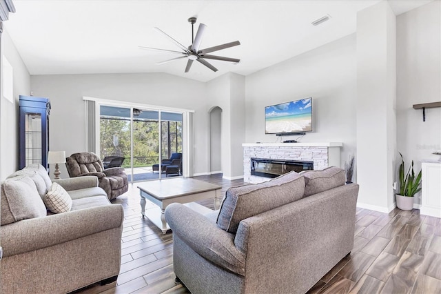 12755 Rainwashed Loop, Parrish, FL 34219 - living room featuring ceiling fan, a fireplace, dark wood finished floors, arched walkways, and baseboards