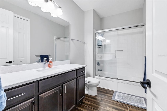 12755 Rainwashed Loop, Parrish, FL 34219 - full bath featuring wood finished floors, toilet, vanity, and enclosed tub / shower combo