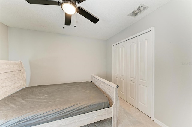 1721 Palm Warbler Ln, Ruskin, FL 33570 - unfurnished bedroom with a closet, carpet floors, a ceiling fan, and a textured ceiling