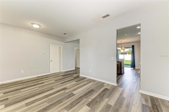 1721 Palm Warbler Ln, Ruskin, FL 33570 - unfurnished room featuring wood finished floors, a textured ceiling, and baseboards