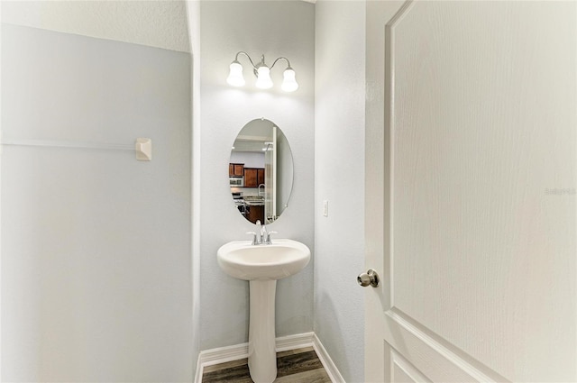 1721 Palm Warbler Ln, Ruskin, FL 33570 - bathroom featuring wood finished floors, baseboards, and a sink