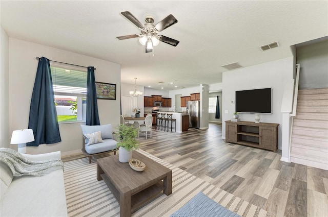 1721 Palm Warbler Ln, Ruskin, FL 33570 - living area with light wood-type flooring, healthy amount of natural light, and a ceiling fan
