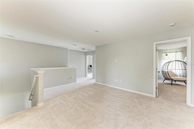 1721 Palm Warbler Ln, Ruskin, FL 33570 - unfurnished room featuring light colored carpet, a textured ceiling, a smoke detector, and baseboards