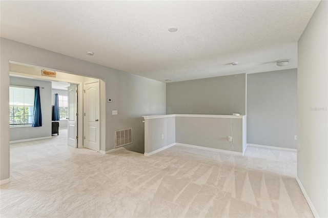 1721 Palm Warbler Ln, Ruskin, FL 33570 - empty room featuring a textured ceiling, carpet floors, and baseboards