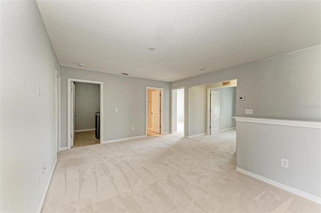 1721 Palm Warbler Ln, Ruskin, FL 33570 - unfurnished room featuring light colored carpet, a textured ceiling, and baseboards