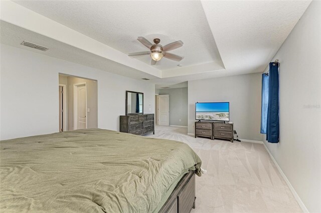 1721 Palm Warbler Ln, Ruskin, FL 33570 - bedroom with light colored carpet, a tray ceiling, baseboards, a ceiling fan, and a textured ceiling