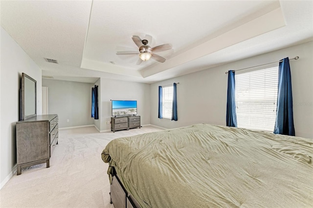 1721 Palm Warbler Ln, Ruskin, FL 33570 - bedroom featuring a tray ceiling, light carpet, baseboards, and a ceiling fan