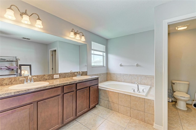 1721 Palm Warbler Ln, Ruskin, FL 33570 - bathroom featuring tile patterned flooring, a bath, toilet, and double vanity