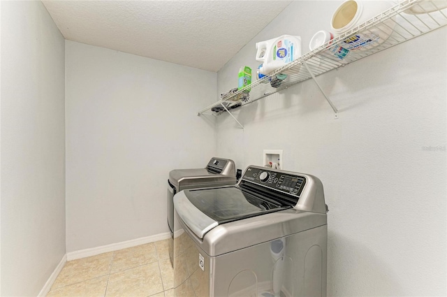 1721 Palm Warbler Ln, Ruskin, FL 33570 - laundry area featuring washer and dryer, baseboards, light tile patterned flooring, and a textured ceiling