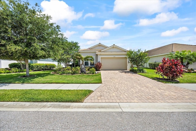 13819 American Prairie Pl, Bradenton, FL 34211 - view of front of house featuring decorative driveway, a garage, and a front yard