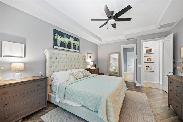 13819 American Prairie Pl, Bradenton, FL 34211 - bedroom featuring a raised ceiling, dark wood-type flooring, baseboards, and a ceiling fan