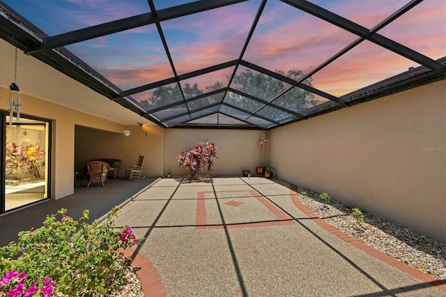 3914 Glen Oaks Manor Dr, Sarasota, FL 34232 - patio terrace at dusk with a patio and glass enclosure