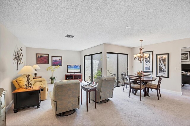 3914 Glen Oaks Manor Dr, Sarasota, FL 34232 - living room featuring carpet floors, a chandelier, a textured ceiling, and baseboards