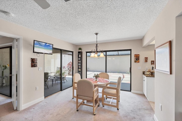 3914 Glen Oaks Manor Dr, Sarasota, FL 34232 - dining space featuring a textured ceiling, light carpet, baseboards, and a ceiling fan