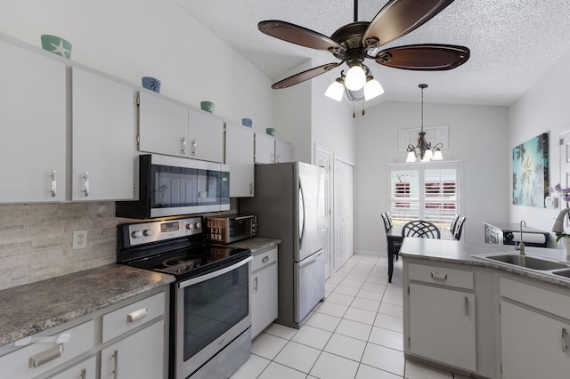 613 E 49th St E, Bradenton, FL 34208 - kitchen featuring stainless steel appliances, a sink, tasteful backsplash, light tile patterned flooring, and a chandelier