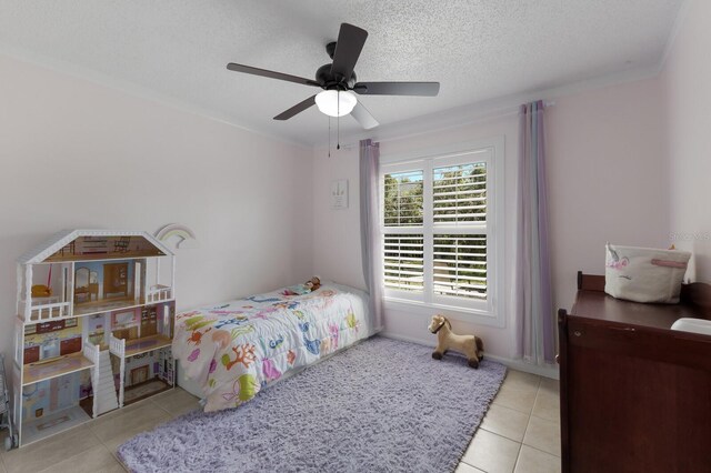 613 E 49th St E, Bradenton, FL 34208 - bedroom featuring tile patterned floors, a ceiling fan, and a textured ceiling