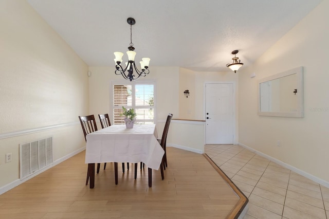 613 E 49th St E, Bradenton, FL 34208 - dining area featuring a chandelier, baseboards, and light wood-style floors