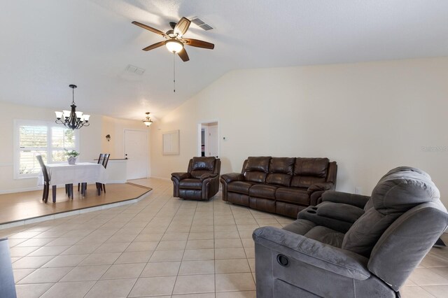 613 E 49th St E, Bradenton, FL 34208 - living room with a chandelier, light tile patterned flooring, lofted ceiling, and a ceiling fan