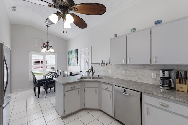 613 E 49th St E, Bradenton, FL 34208 - kitchen with dishwasher, a sink, stainless steel refrigerator, a textured ceiling, and a ceiling fan