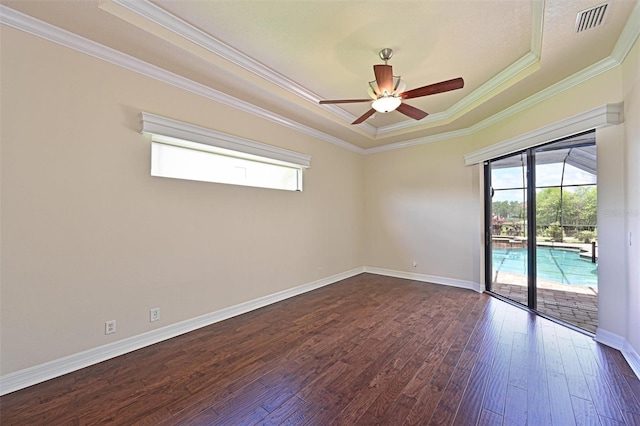 12644 20th St E, Parrish, FL 34219 - spare room with a raised ceiling, crown molding, ceiling fan, dark wood finished floors, and baseboards